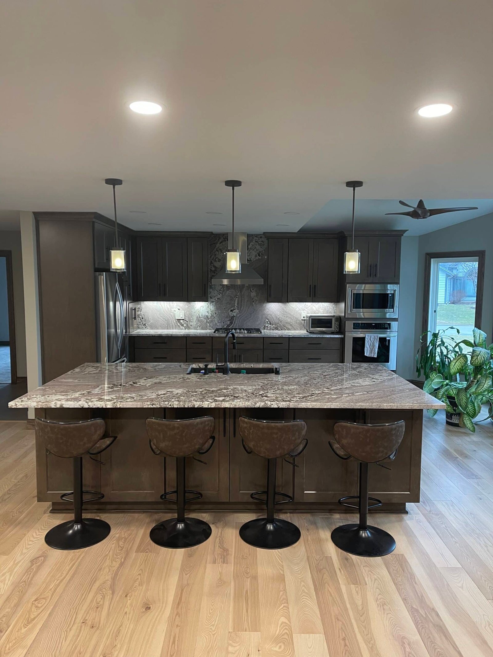 Before and after of a remodeled Pewaukee colonial kitchen with quartz countertops and semi-custom cabinets
