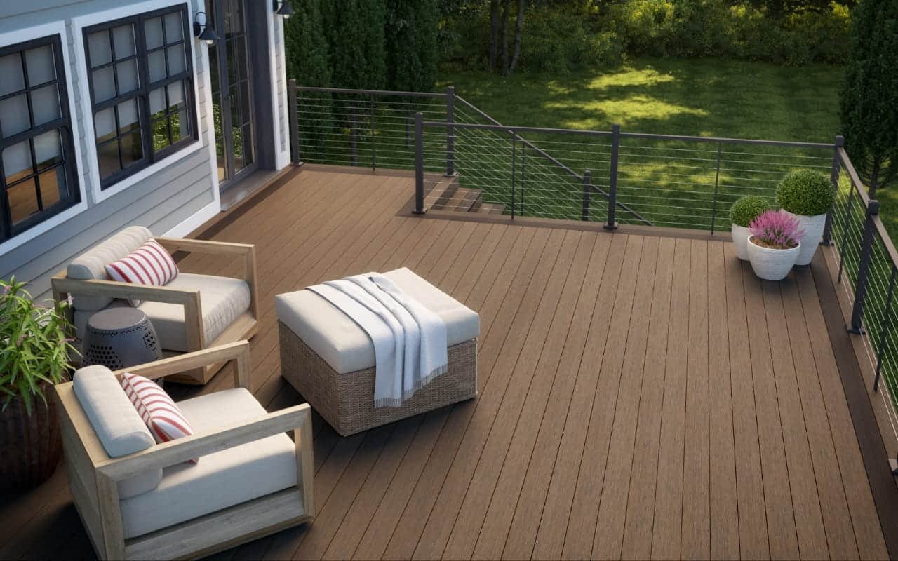 Wisconsin composite deck with cable railing and frost-depth footings on a Waukesha County home