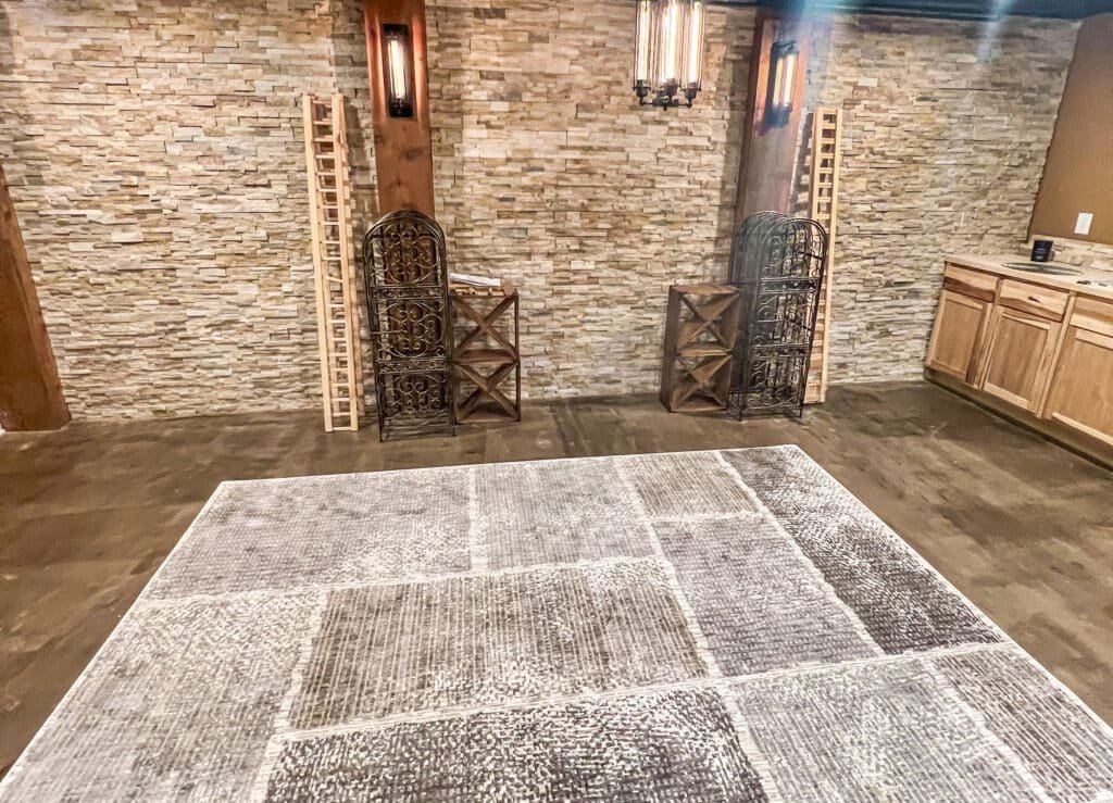 High-end finished basement with coffered ceiling, engineered hardwood flooring, and recessed lighting in a Waukesha County home