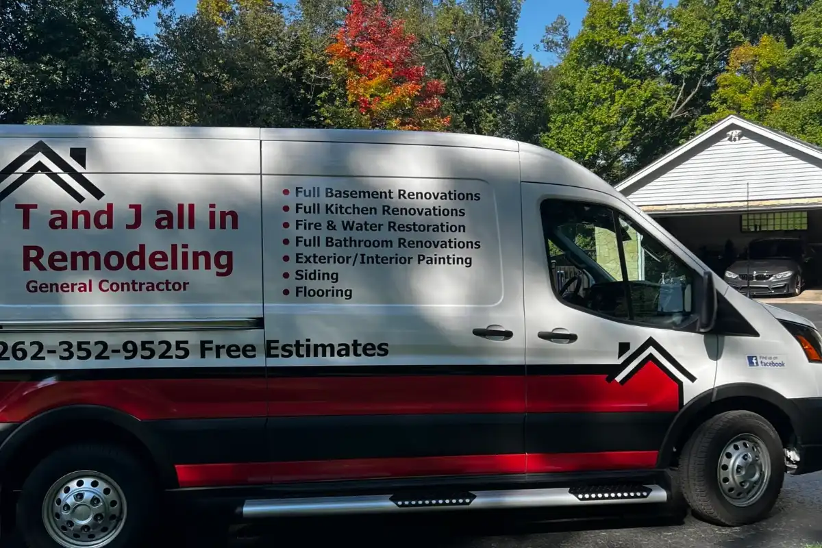 T And J All In Remodeling service van with the company service list and phone number on the side, parked in a Wisconsin driveway