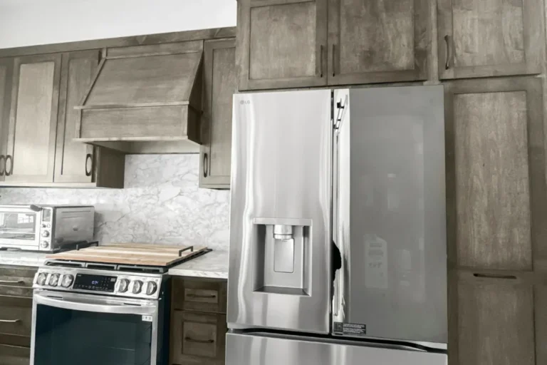 Custom wood hood above the range and marble backsplash, a completed T And J kitchen remodel in Southeastern Wisconsin