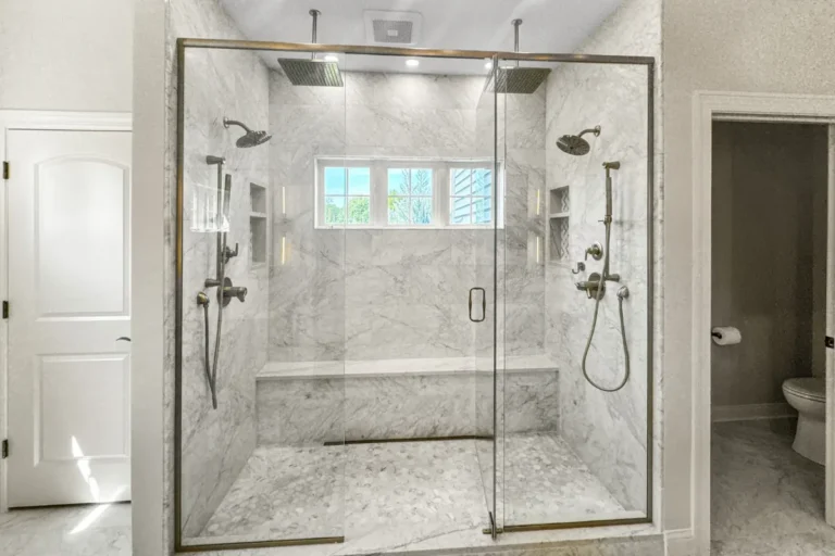 Marble shower with dual heads and a full bench, a completed T And J bathroom remodel in Southeastern Wisconsin